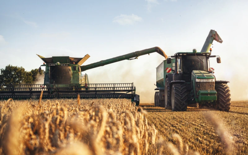 Large tractor collecting crops in a field
